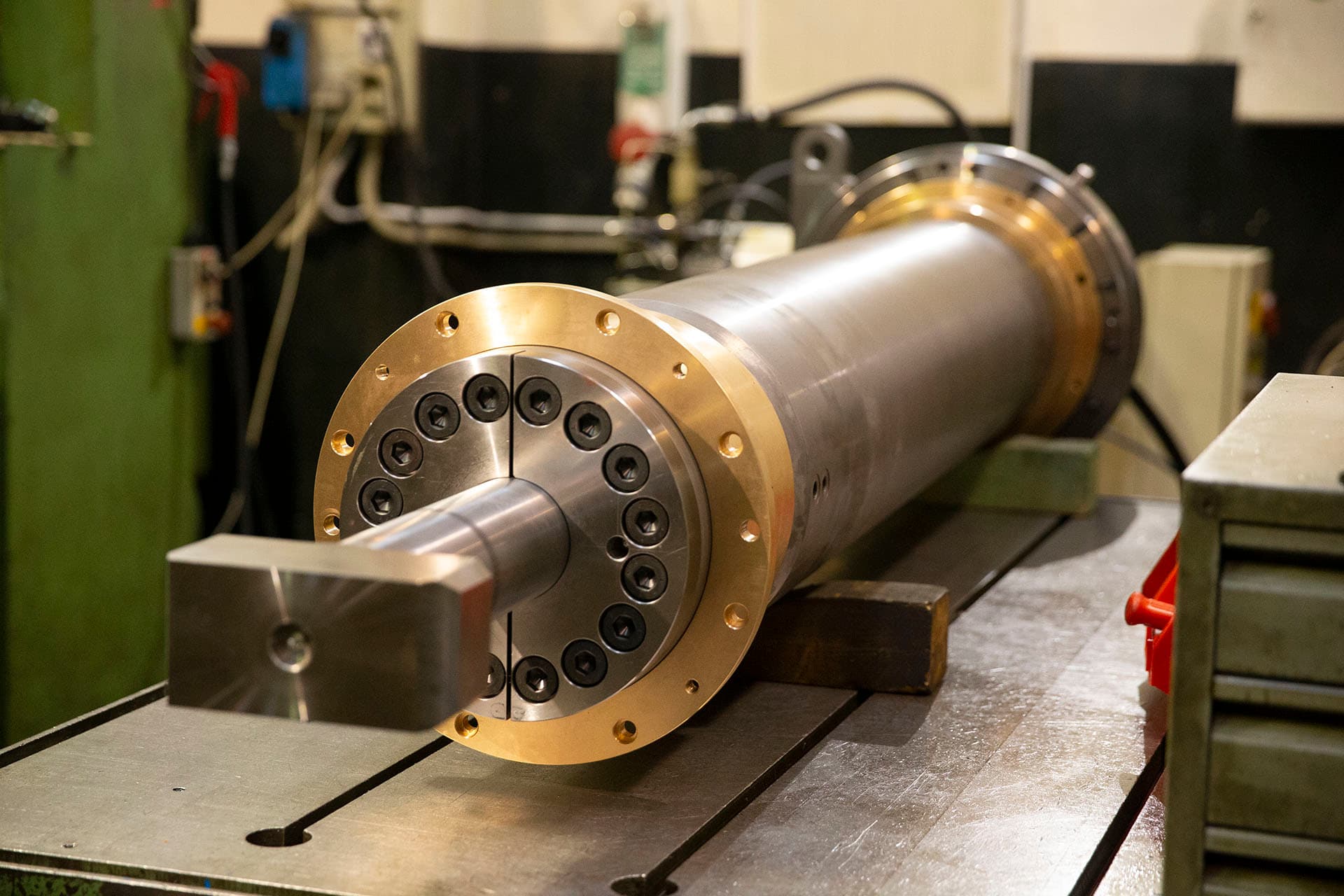 Cylinder with a bronze end cover and square rod end on a machine table