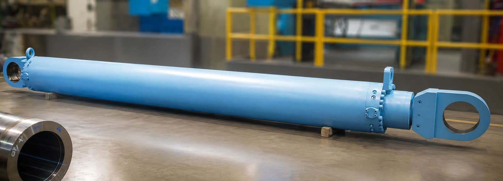 Light blue knuckle boom crane cylinder with a rod eye