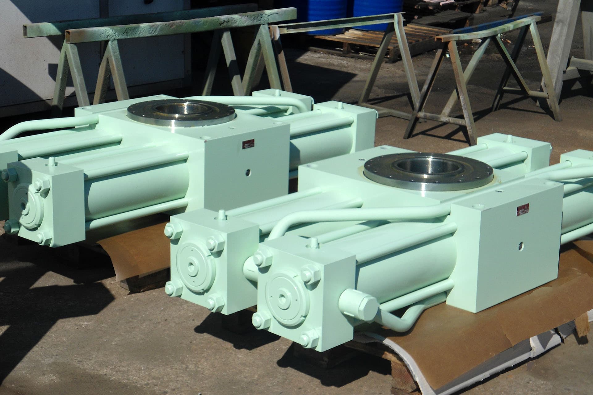 Two light green rack-and-pinion rotary actuators with rectangular heads and output shaft flange