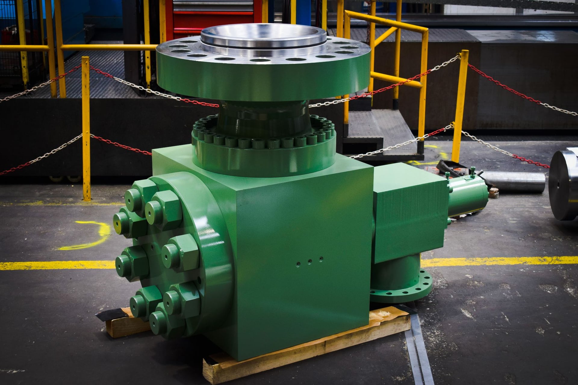 Green prefill valve on a wooden pallet, three-quarter view of the body and tank flange