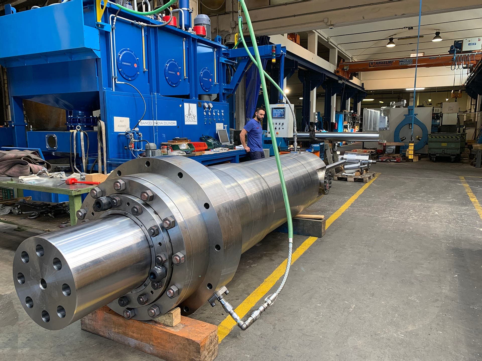Long steel cylinder on supports connected by a hose for testing