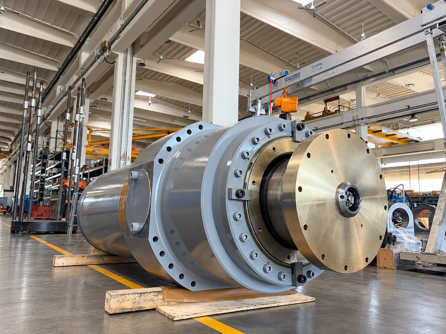 Large cylinder with a polished steel end cover on a pallet in a bright hall
