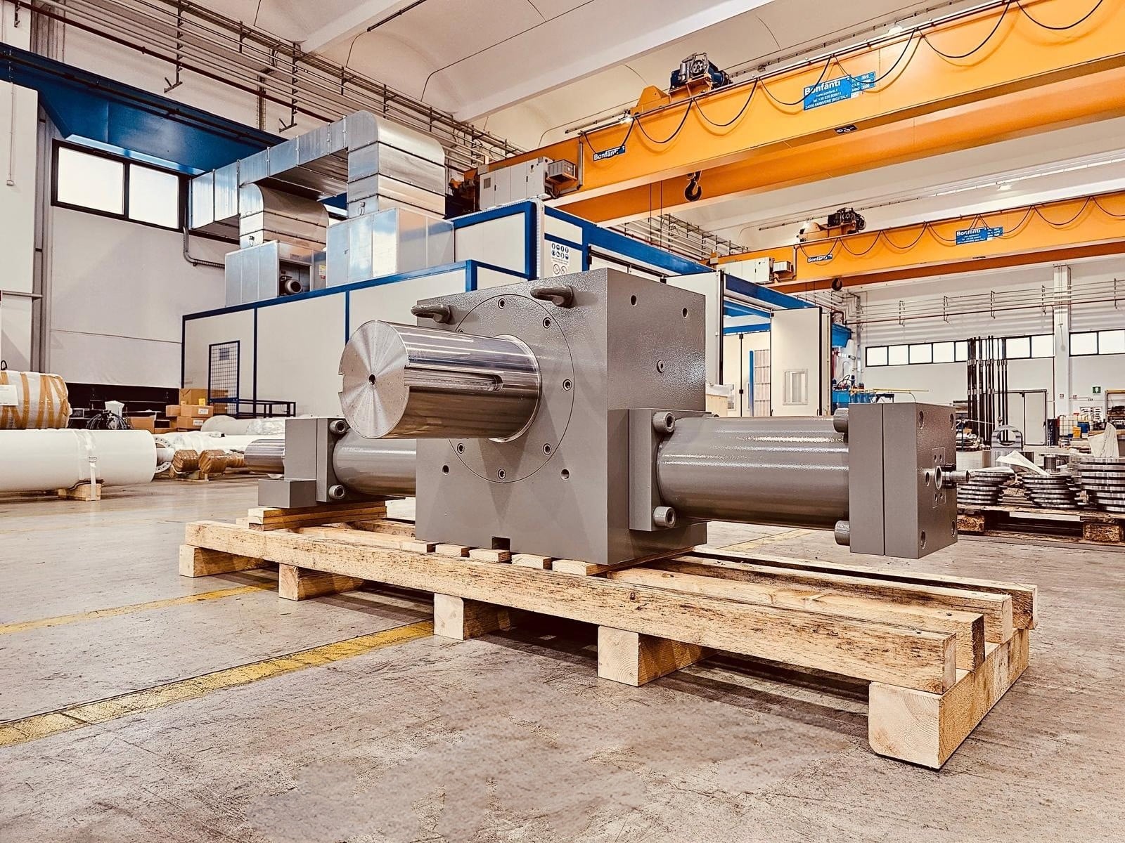 Steel rotary actuator with output shaft on a wooden pallet in the workshop